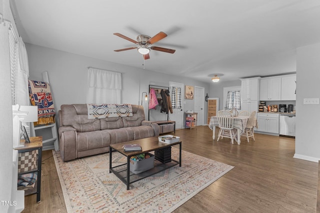 living room featuring ceiling fan and wood-type flooring