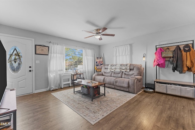 living room with wood-type flooring and ceiling fan