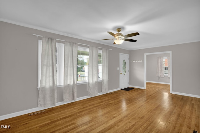 entryway featuring hardwood / wood-style floors, ceiling fan, and ornamental molding