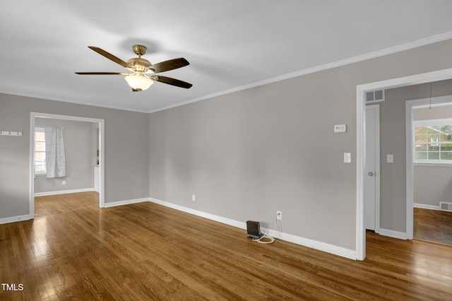 unfurnished room with hardwood / wood-style floors, ceiling fan, and crown molding