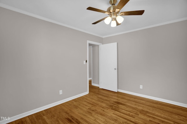 spare room featuring ceiling fan, wood-type flooring, and ornamental molding