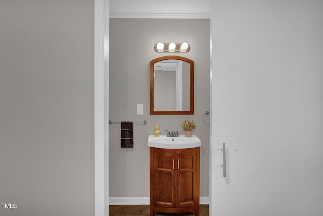 bathroom with vanity and ornamental molding