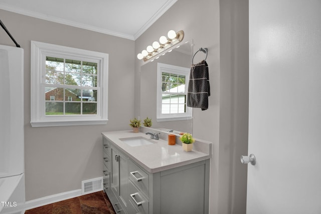 bathroom with vanity, crown molding, a wealth of natural light, and bathtub / shower combination