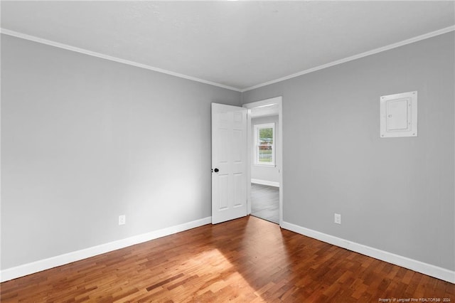 unfurnished room featuring hardwood / wood-style floors and crown molding