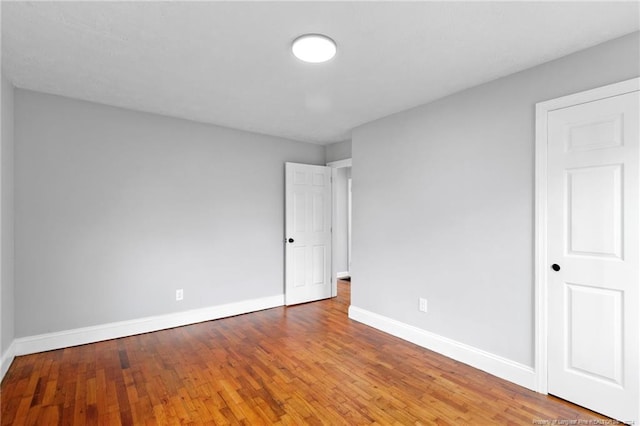 empty room with wood-type flooring