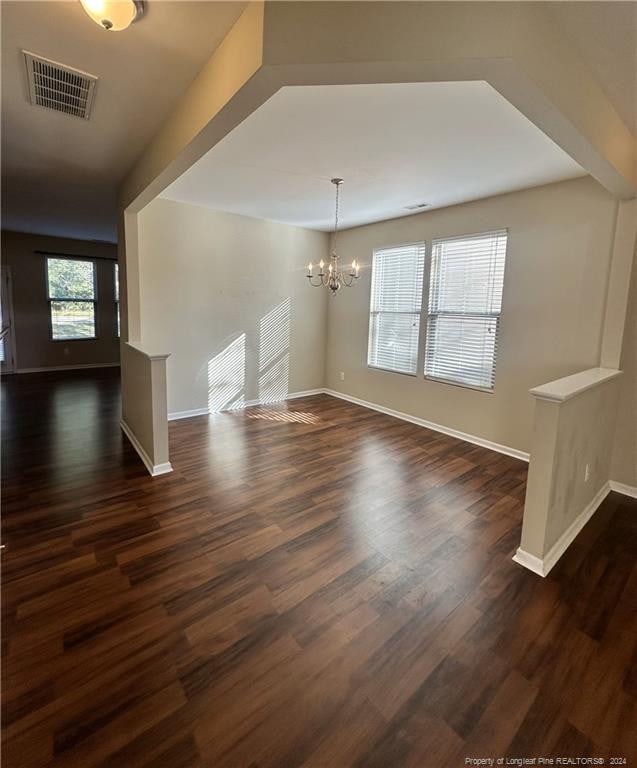 interior space featuring dark hardwood / wood-style floors and a chandelier