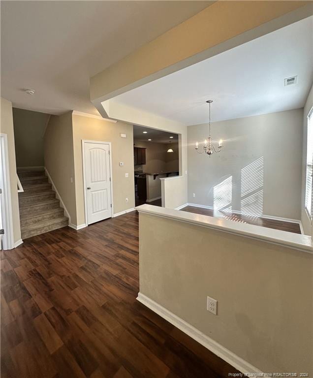 interior space featuring a chandelier and dark hardwood / wood-style floors