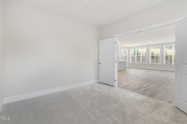 empty room with light hardwood / wood-style flooring