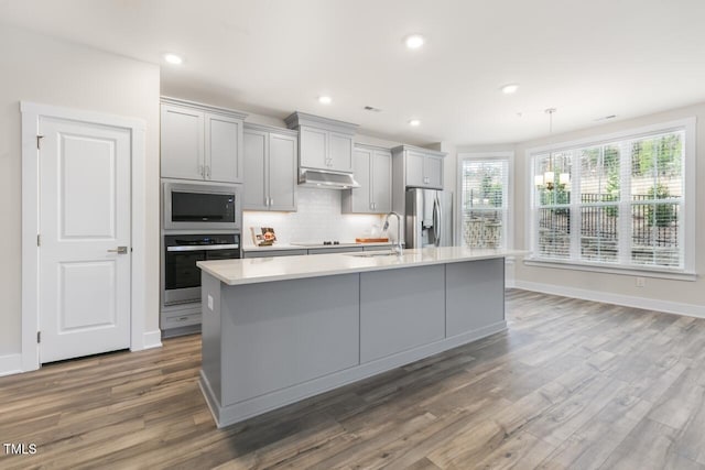 kitchen with dark hardwood / wood-style flooring, stainless steel appliances, gray cabinets, and sink