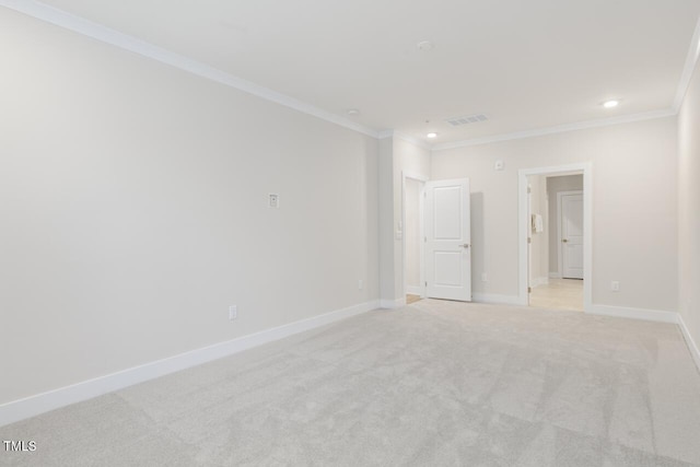 unfurnished room featuring crown molding and light colored carpet