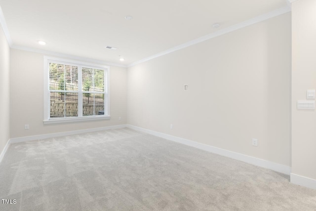 spare room featuring light colored carpet and ornamental molding