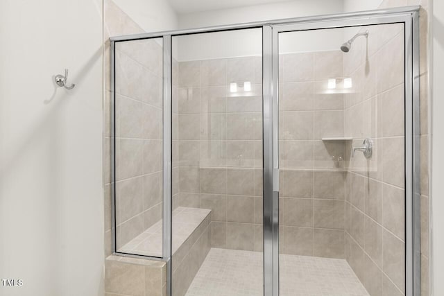 bathroom featuring a shower with door