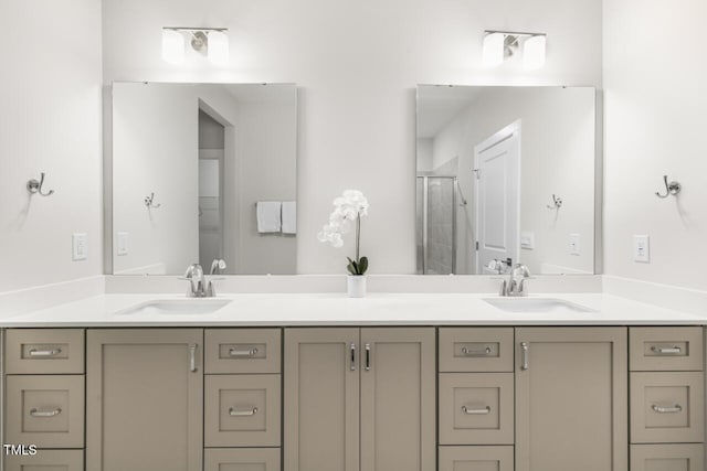 bathroom with vanity and a shower with shower door