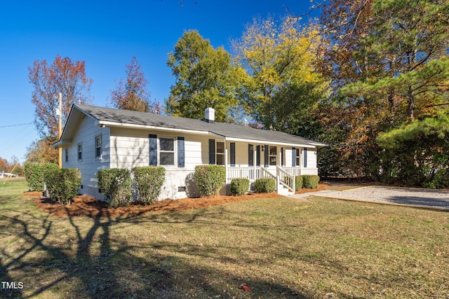 ranch-style house with a porch and a front yard