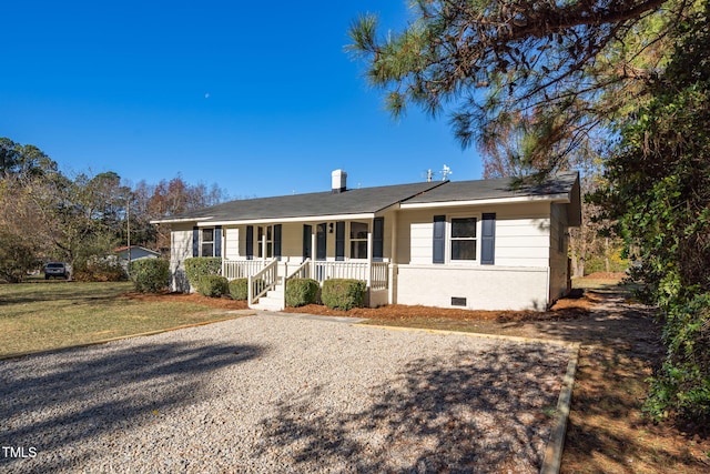 ranch-style house with covered porch and a front yard