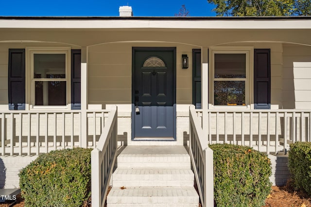 doorway to property with covered porch