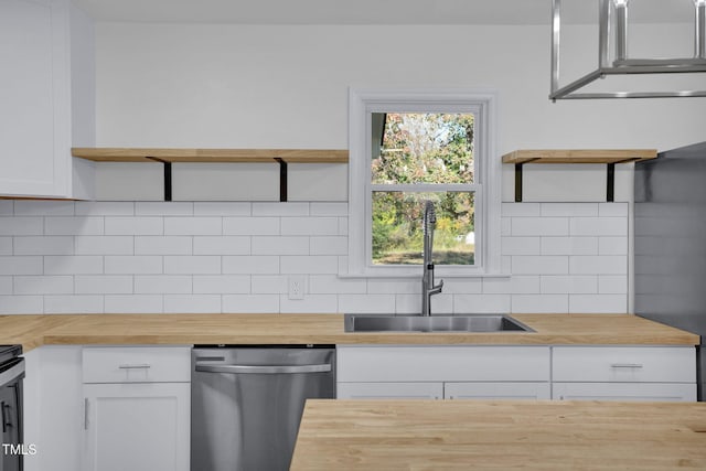 kitchen featuring white cabinets, tasteful backsplash, sink, dishwasher, and butcher block countertops