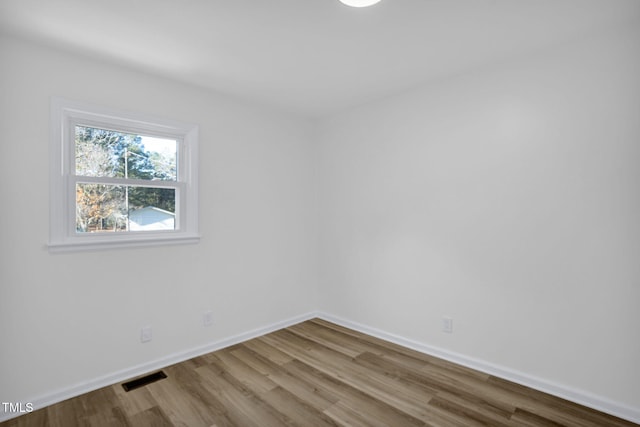 spare room featuring hardwood / wood-style flooring