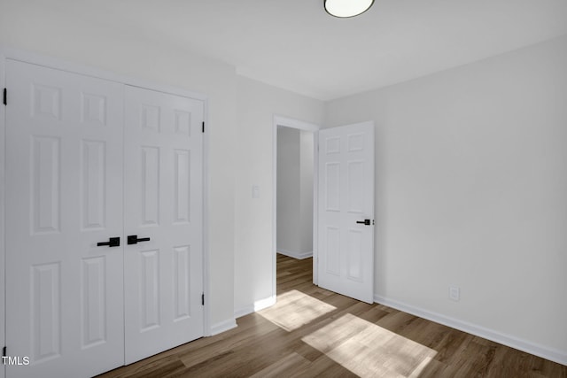 unfurnished bedroom with light hardwood / wood-style floors and a closet