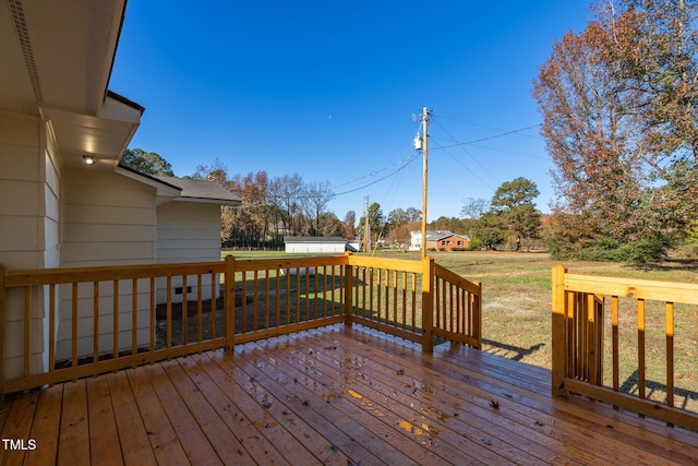 wooden deck featuring a yard