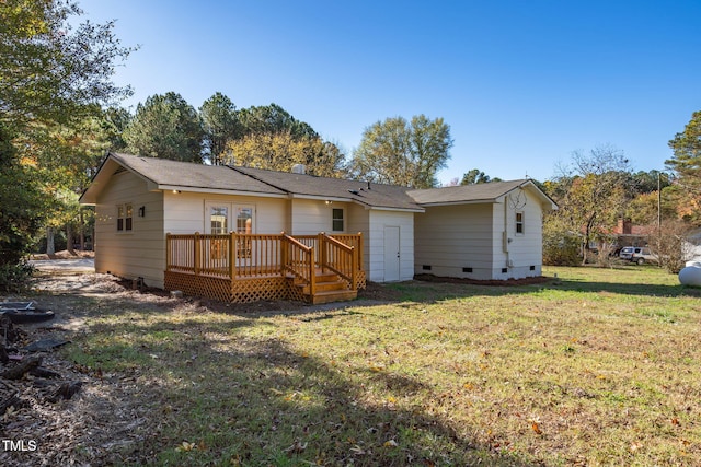 back of house with a deck, a yard, and french doors