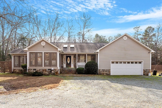 single story home featuring a garage and a sunroom