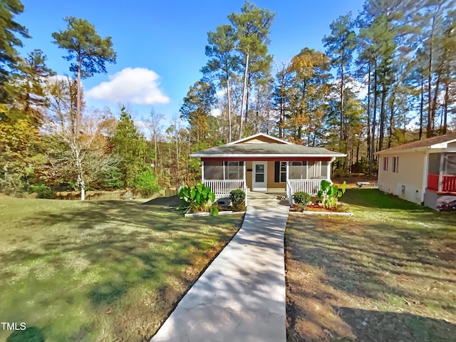 view of front of home with covered porch and a front lawn