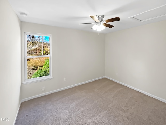 carpeted empty room featuring ceiling fan