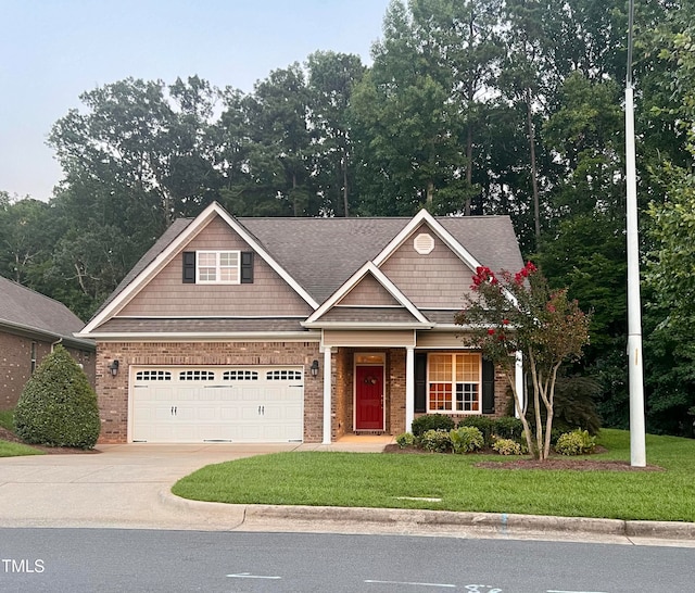 craftsman-style house featuring a front yard and a garage