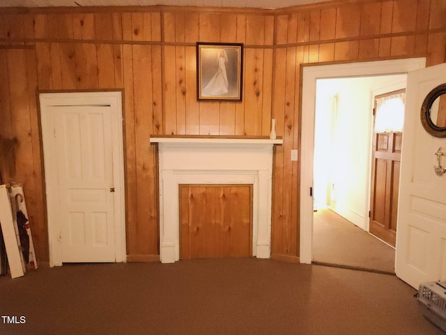 unfurnished living room featuring wooden walls