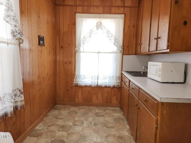 kitchen with wooden walls and sink