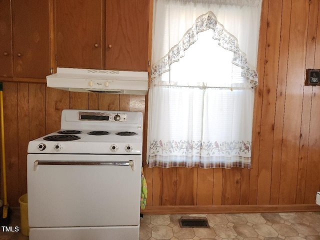 kitchen featuring wood walls and white electric stove