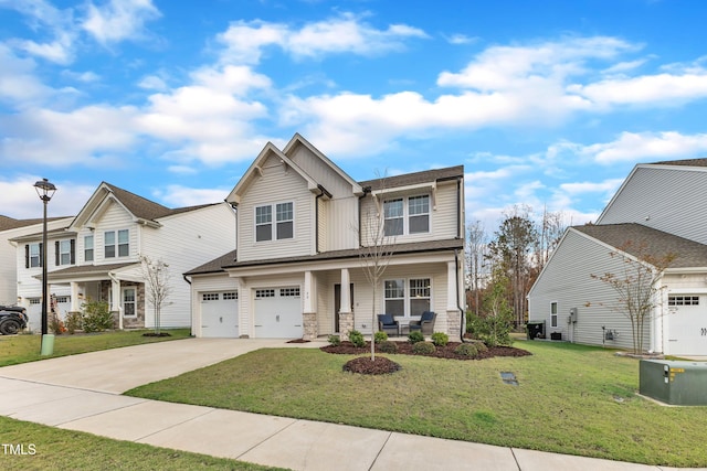 view of front of property featuring covered porch, a front yard, and a garage