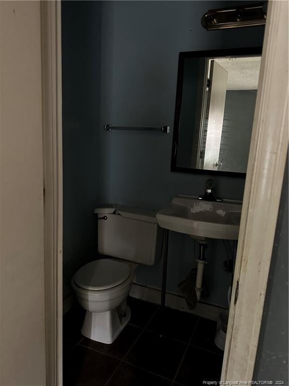 bathroom with sink, tile patterned flooring, and toilet