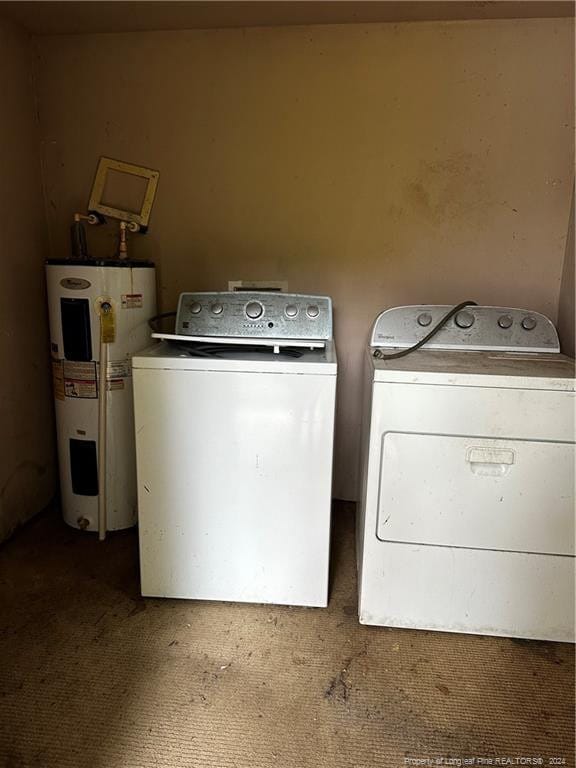 laundry area with washing machine and clothes dryer, electric water heater, and carpet flooring