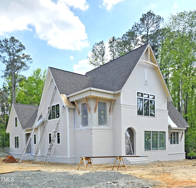 view of front of house with roof with shingles