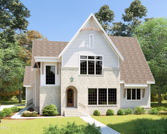 view of front of property featuring entry steps, a shingled roof, a front yard, and brick siding