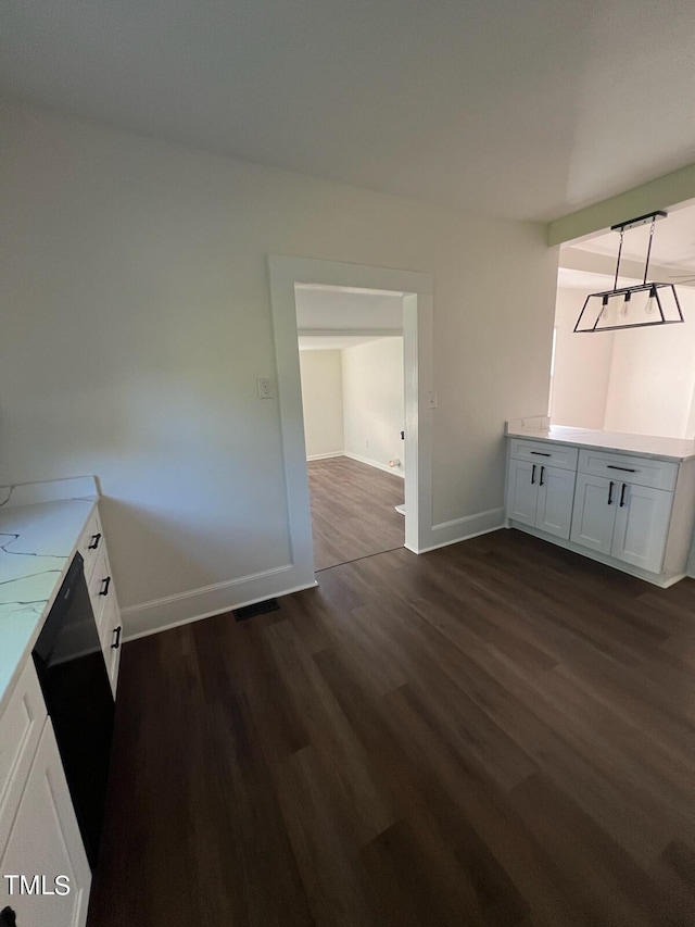 unfurnished dining area featuring dark hardwood / wood-style flooring