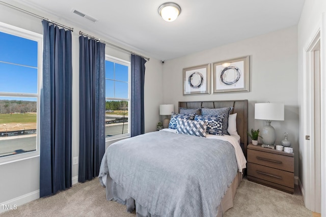 bedroom featuring light colored carpet