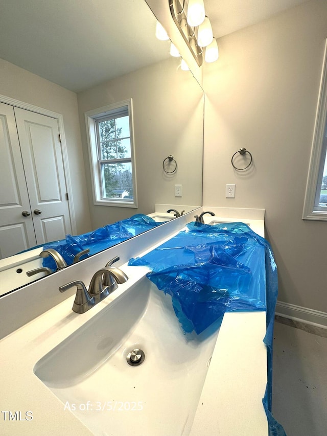 bathroom with vanity and baseboards