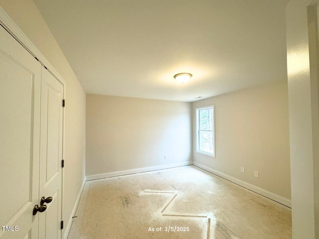 unfurnished bedroom featuring a closet and baseboards