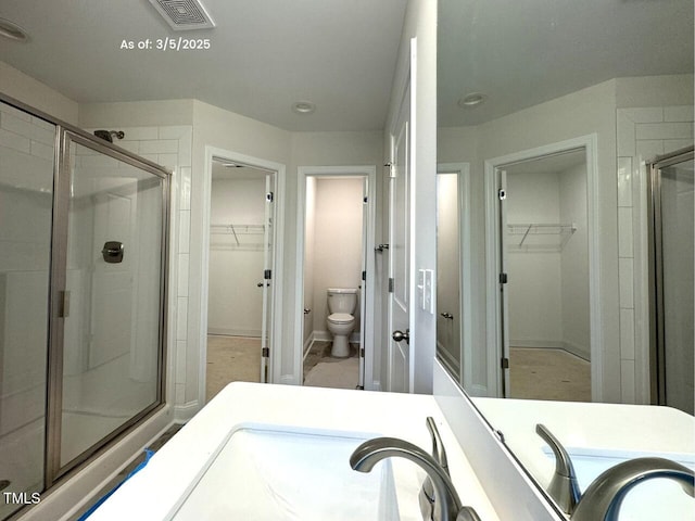 full bathroom featuring toilet, a stall shower, and visible vents