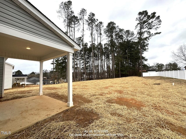 view of yard featuring fence and a patio