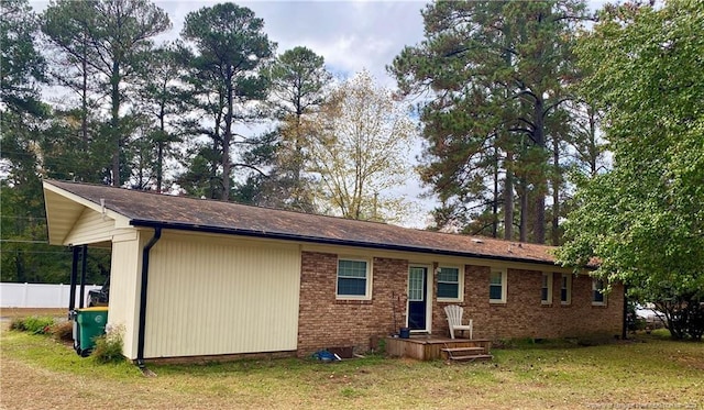 back of property featuring a lawn