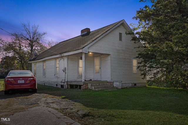 bungalow-style home with a lawn