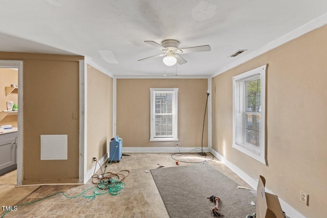 unfurnished room featuring ceiling fan, crown molding, and light carpet