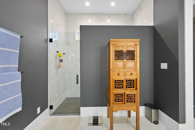 bathroom with a shower with shower door