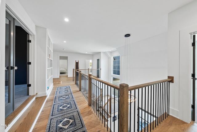 hallway with light hardwood / wood-style flooring