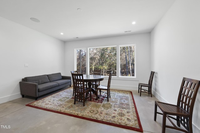 dining room with concrete flooring