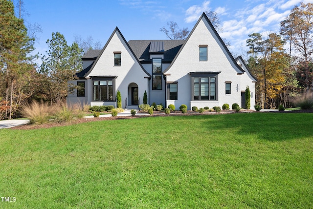 english style home featuring a front lawn